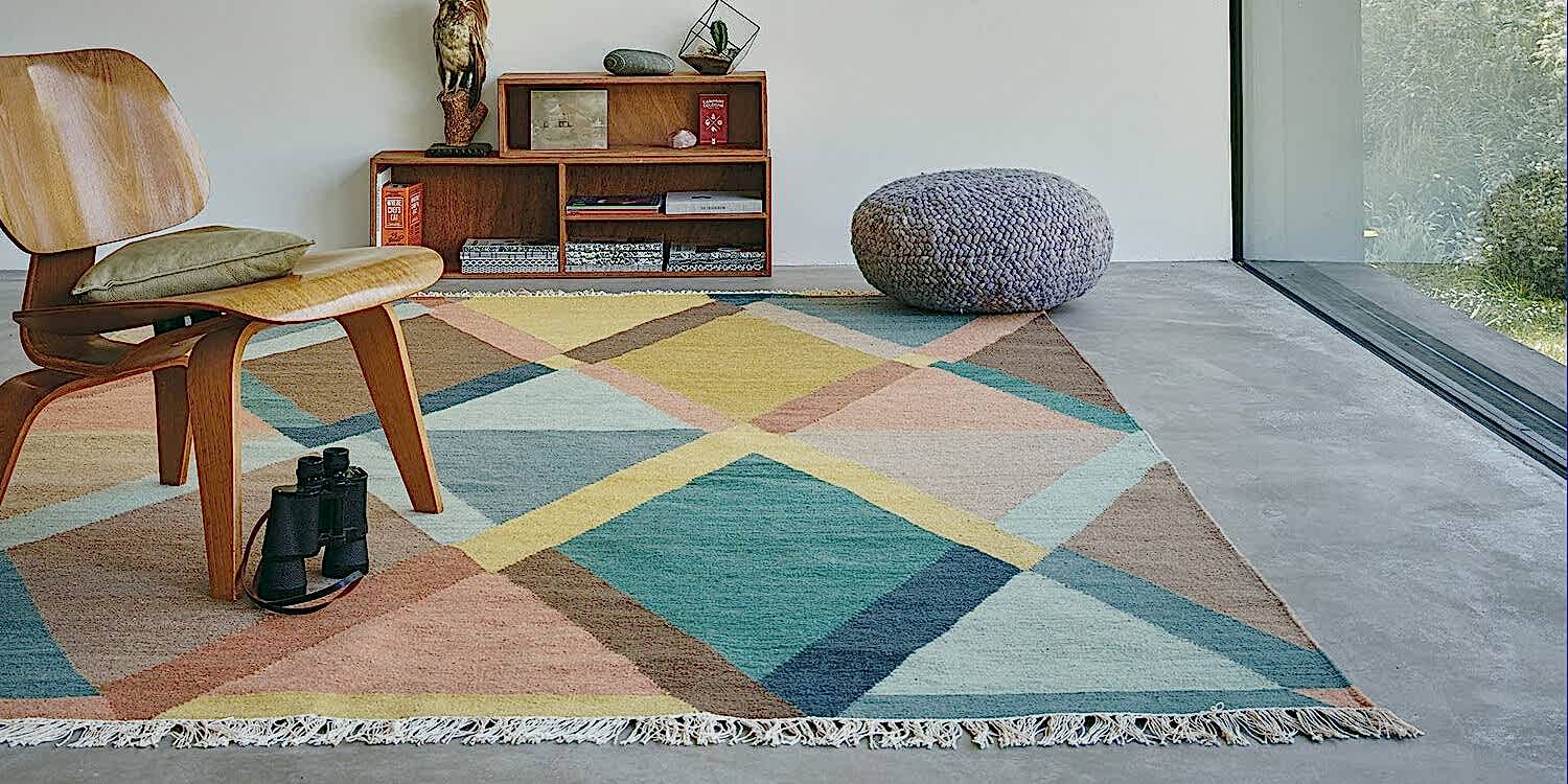 Barbers Flooring | Guide | image showing a multi color rug in a bedroom